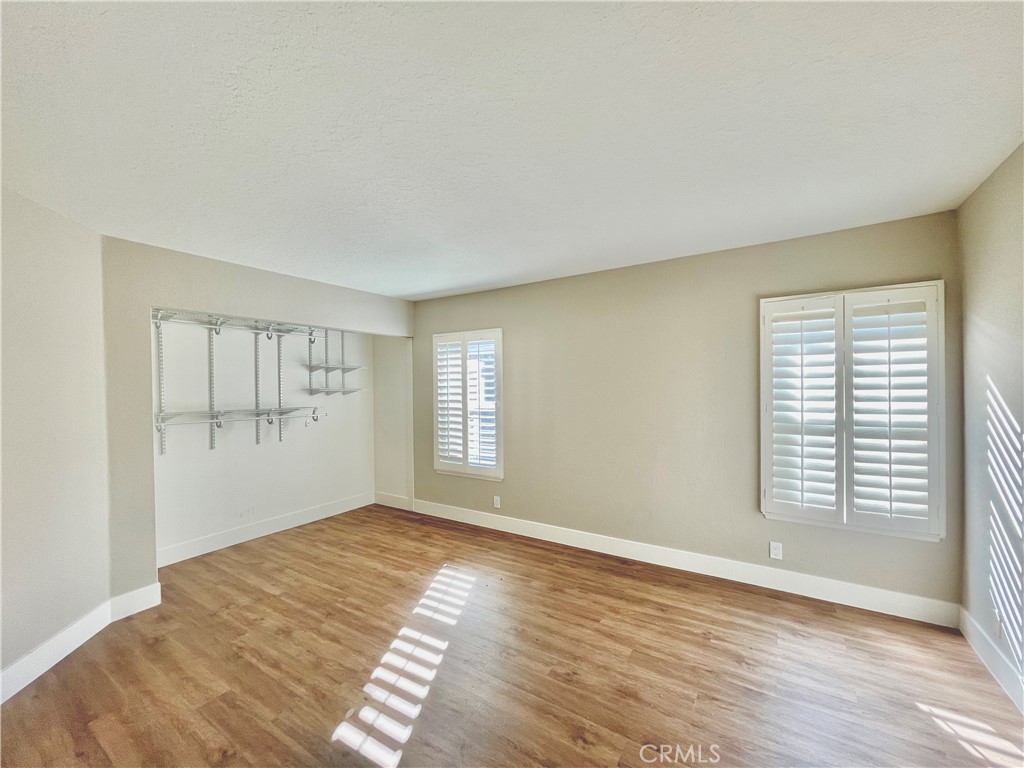 10 Ramada Irvine, CA 92620 - Photo 19 of 22 a view of empty room with wooden floor and fan