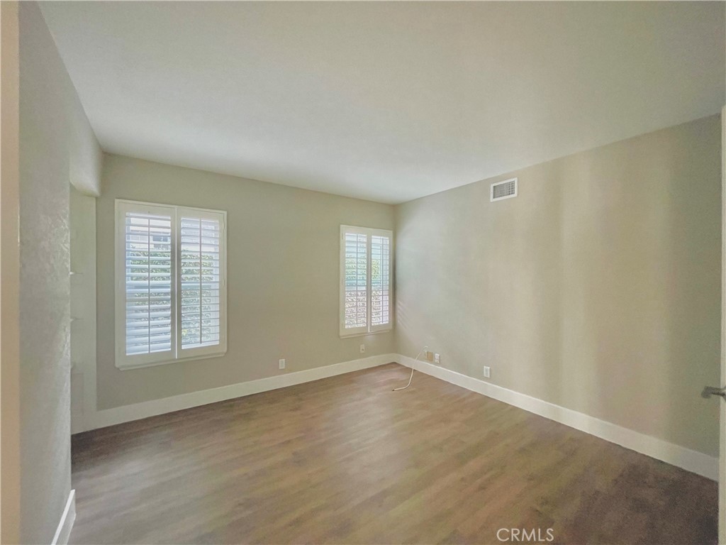 10 Ramada Irvine, CA 92620 - Photo 7 of 22 an empty room with wooden floor and windows