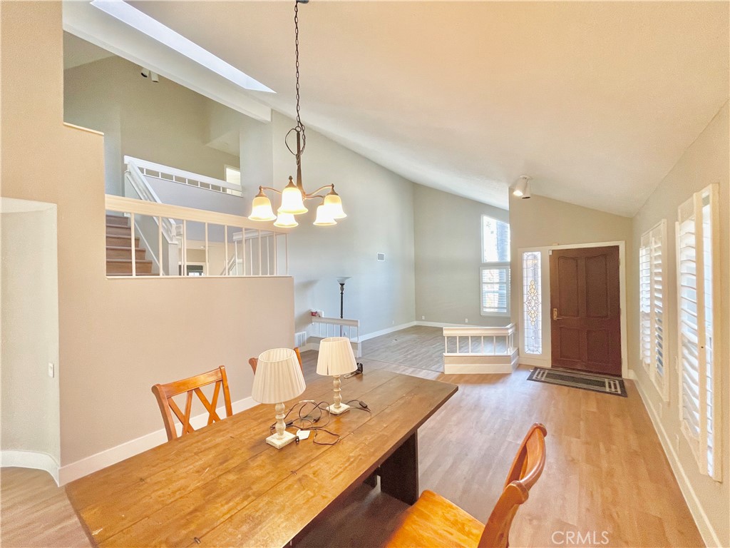 10 Ramada Irvine, CA 92620 - Photo 9 of 22 a living room with furniture a dining table and a chandelier