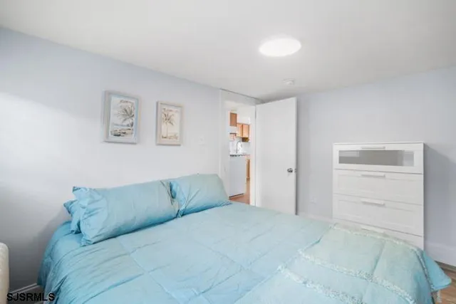 a living room with a couch and a view of kitchen