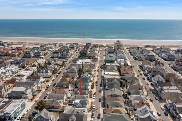 an aerial view of a building and ocean view