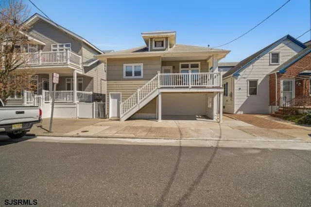 a front view of a house with a road