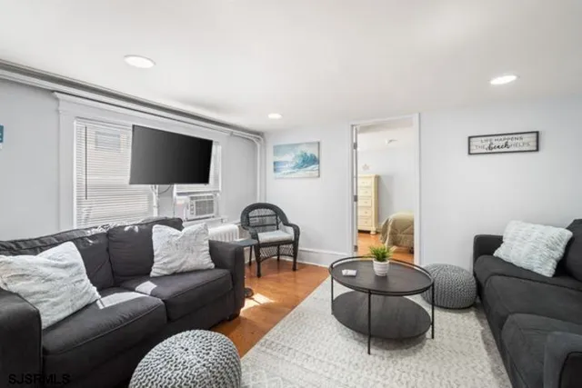 a living room with furniture and a flat screen tv