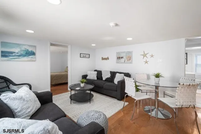 a living room with furniture and wooden floor