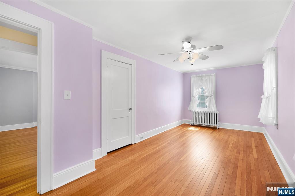 106 Maple Street Rutherford, NJ 07070 - Photo 30 of 50 a view of empty room with wooden floor and fan