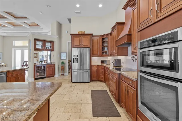 a kitchen with stainless steel appliances granite countertop a refrigerator and a stove