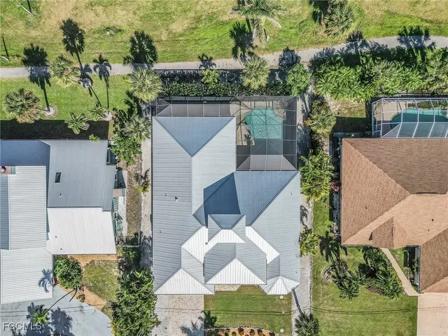 an aerial view of a house with a yard