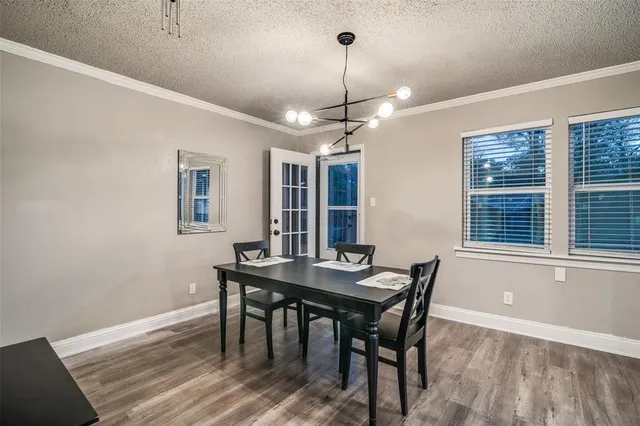 a view of an empty room with wooden floor fireplace and a window