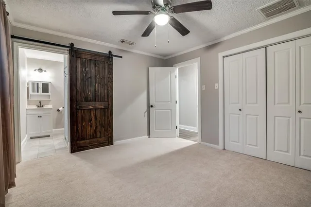 a view of an empty room with a ceiling fan