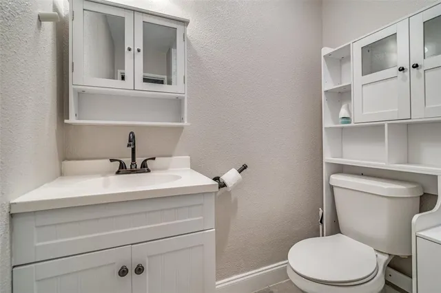 a bathroom with a sink a toilet and mirror