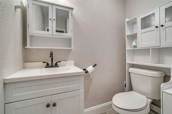 a bathroom with a sink a toilet and mirror