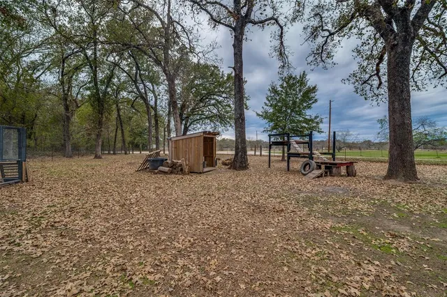 a backyard of a house with table and chairs