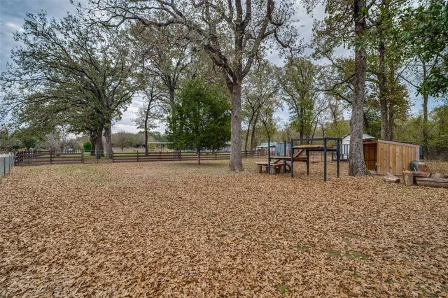 a view of backyard with outdoor seating and green space