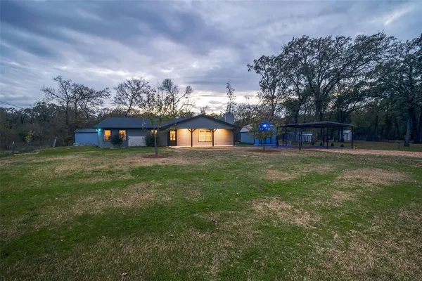 a view of a house with a backyard