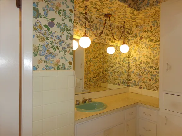 a bedroom with a bed and painting on the wall