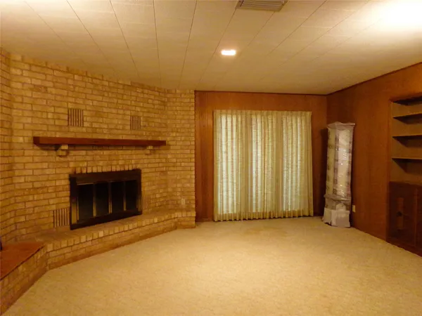 a view of an empty room with a fireplace