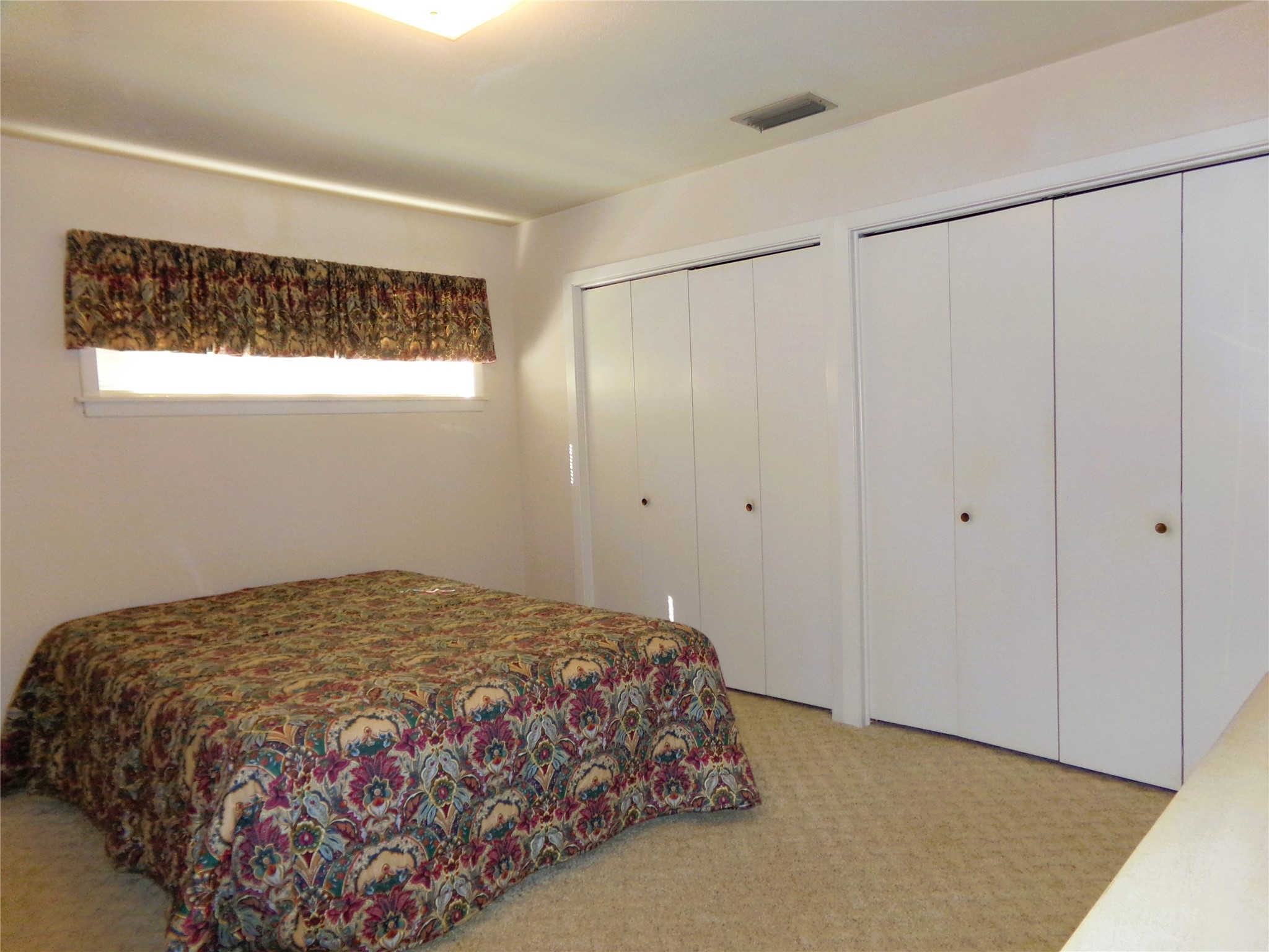 516 North College Street Weimar, TX 78962 - Photo 8 of 20 a bedroom with a bed and a window