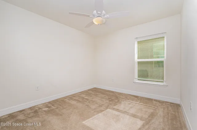 an empty room with a window and closet