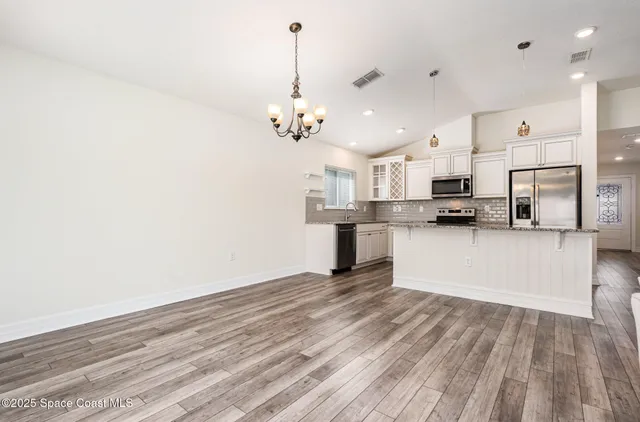 a view of a kitchen with stove and cabinets