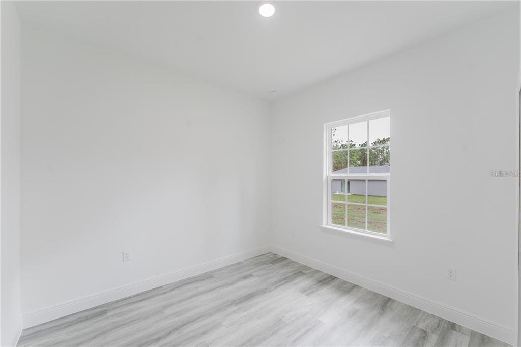 6732 Southwest 132nd Street Ocala, FL 34473 - Photo 22 of 36 an empty room with a window