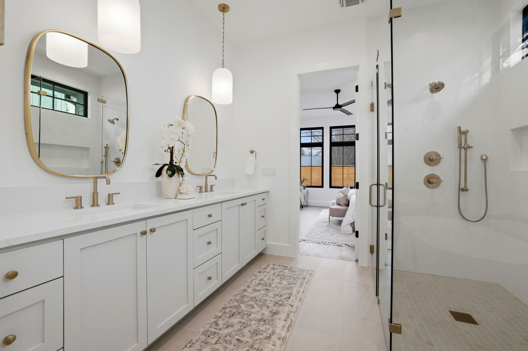 6611 Lexington Road Austin, TX 78757 - Photo 21 of 36 a bathroom with a double vanity sink mirror and shower