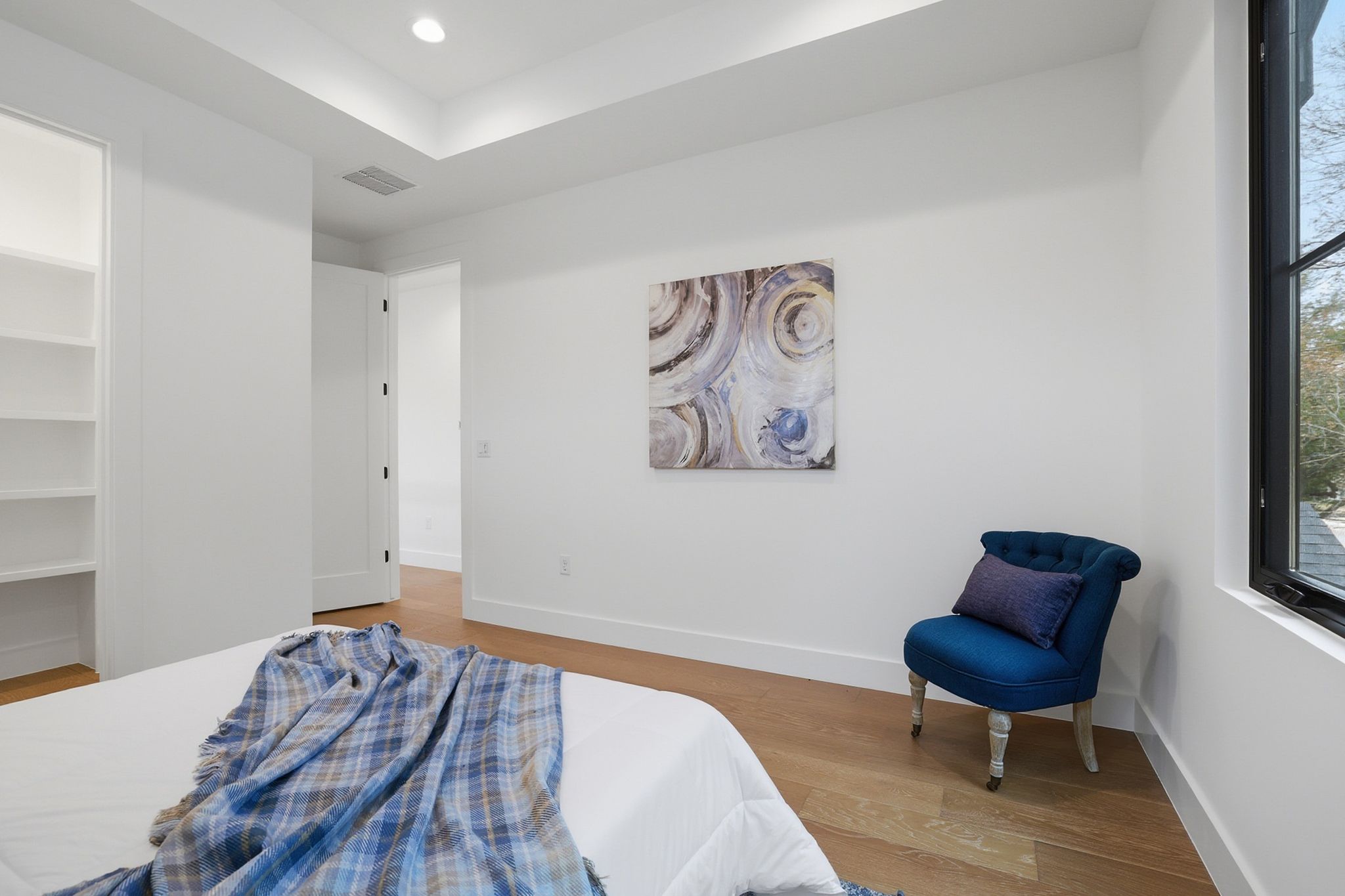 6611 Lexington Road Austin, TX 78757 - Photo 23 of 36 a bedroom with a bed and a chair