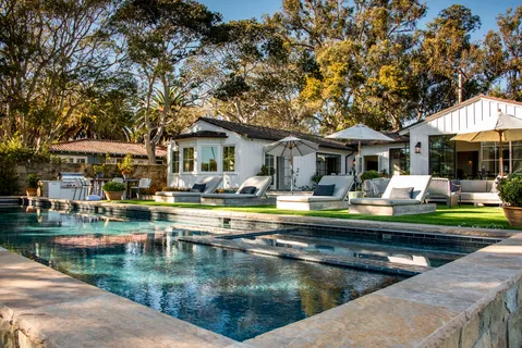 a view of a patio with swimming pool table and chairs