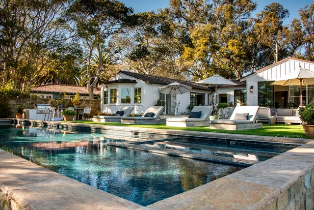 a view of a patio with swimming pool table and chairs