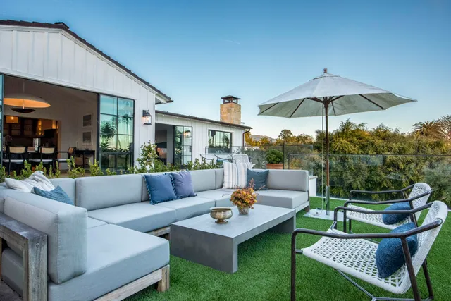 a view of a patio with couches and a table and chairs