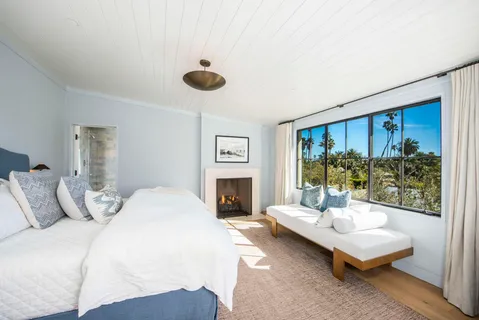 a bedroom with a bed and a fireplace