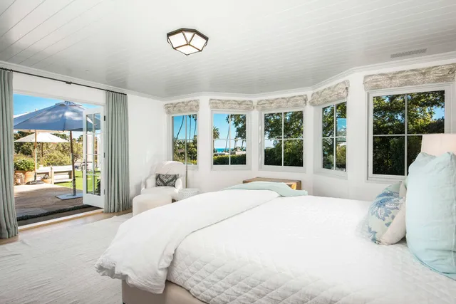 a bedroom with a large bed and a large window