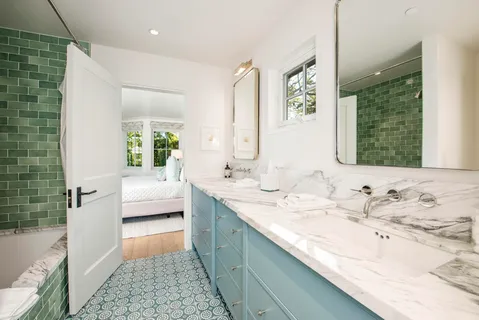 a spacious bathroom with a tub sink and mirror