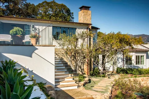 a view of a house with wooden fence