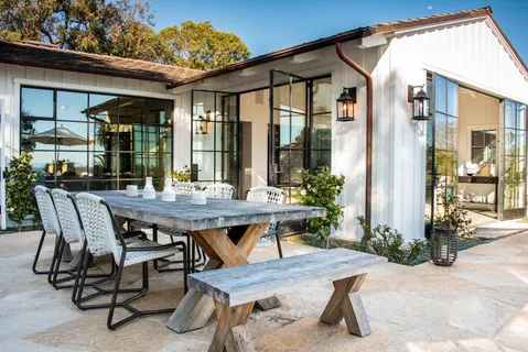 a view of a patio with table and chairs and potted plants