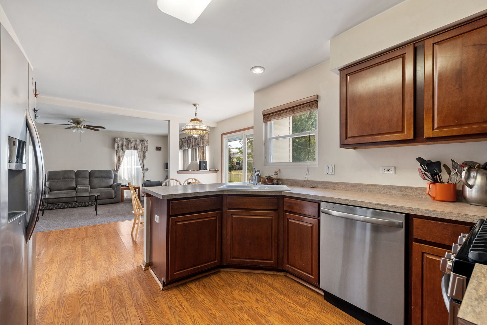 601 Greystone Lane Bolingbrook, IL 60440 - Photo 7 of 20 a kitchen with stainless steel appliances granite countertop wooden cabinets a sink and dishwasher