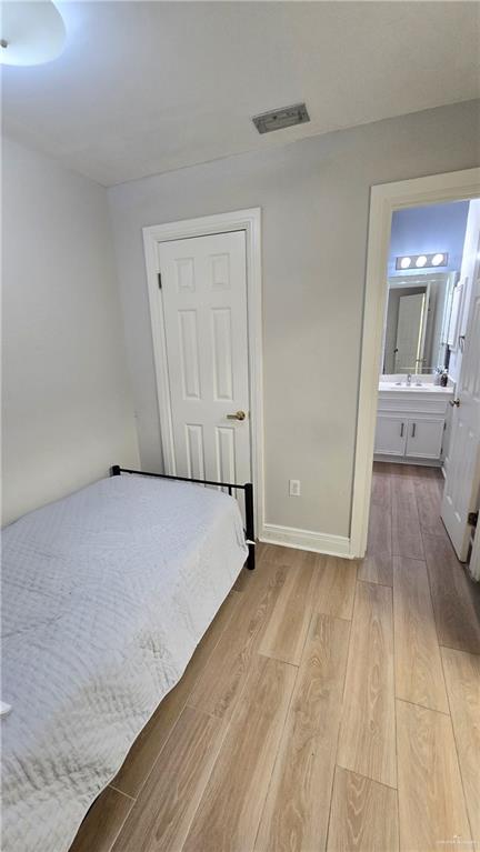 2202 Colorado Street Mission, TX 78572 - Photo 12 of 19 Bedroom with light wood-type flooring and connected bathroom
