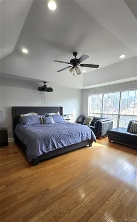 a bedroom with a large bed and a large window