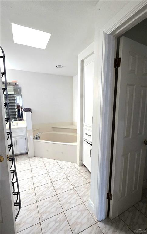 2202 Colorado Street Mission, TX 78572 - Photo 15 of 19 Bathroom with a skylight, vanity, and a bath