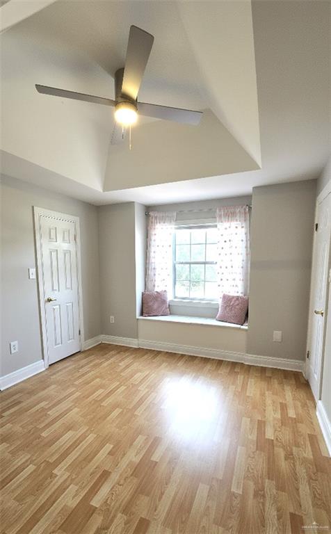 2202 Colorado Street Mission, TX 78572 - Photo 18 of 19 Unfurnished bedroom with light wood-style flooring, ceiling fan, and a tray ceiling