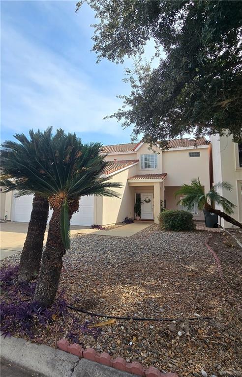2202 Colorado Street Mission, TX 78572 - Photo 2 of 19 Mediterranean / spanish-style home with stucco siding, a tile roof, and an attached garage