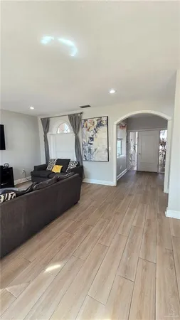a living room with furniture a window and dresser