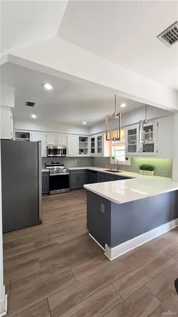 a large kitchen with stainless steel appliances granite countertop a large counter top and stove