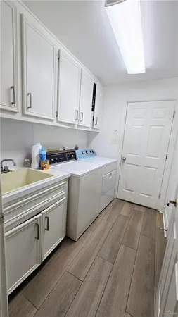 a utility room with cabinets washer and dryer