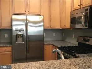 a kitchen with a refrigerator stove and cabinets