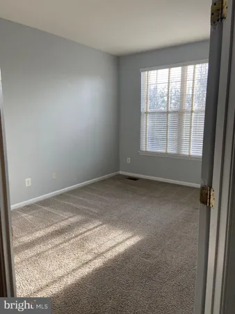 an empty room with a empty space and windows