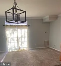 a room with a window and ceiling fan