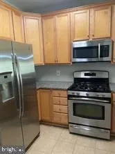 a kitchen with stainless steel appliances granite countertop a stove a microwave and a refrigerator
