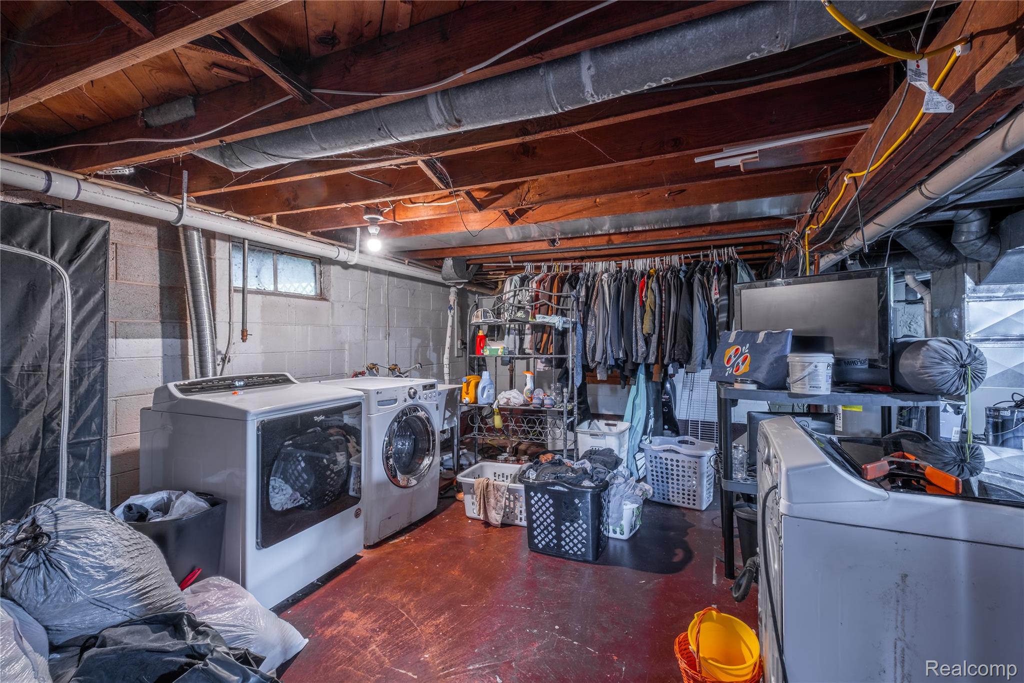7800 Maple Street Birch Run, MI 48415 - Photo 15 of 29 Basement laundry area with concrete block walls and exposed ceiling joists