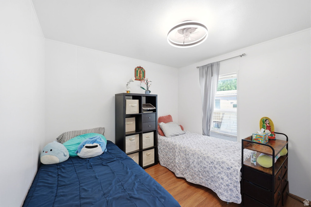 1525 South 400 East, Unit 13 Springville, UT 84663 - Photo 21 of 32 Bright room featuring light wood-finish flooring, white walls, and a contemporary ceiling light fixture