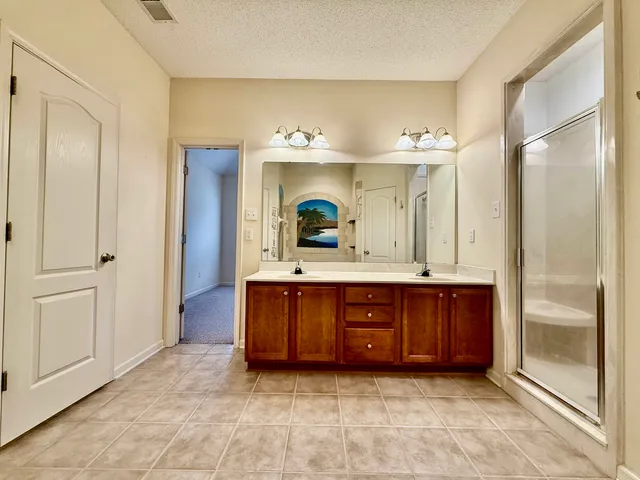 a bathroom with a tub sink and mirror